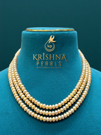 Timeless Radiance – Three-Strand Peach Pearl Necklace